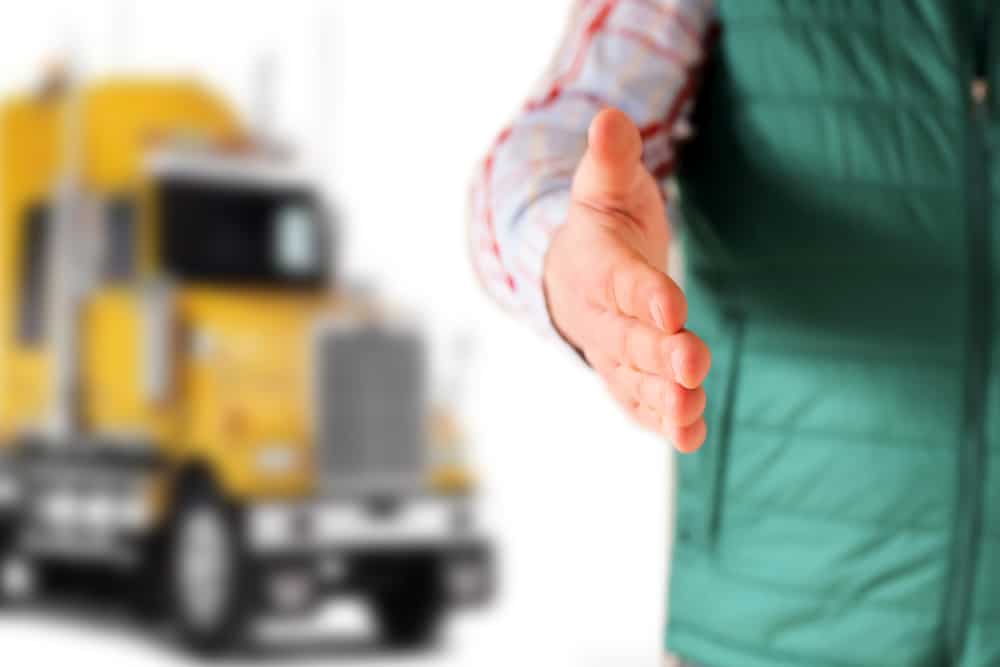 Driver,With,An,Open,Hand,Greeting,.,Truck,Behind,Him
